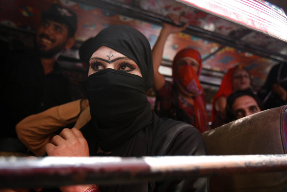 Some of several dozen detained Pakistani transgender people watch from a police bus as another transgender woman and a man are taken to a courthouse to face charges in Peshawar on May 25, 2010. Everyone on the bus was later jailed. Pakistani police arrested what they said was an entire wedding party at a ceremony between a man and a transgender woman, accusing the pair of promoting homosexuality in the devoutly Muslim country. Almost 50 people were at the ceremony in the northwestern city of Peshawar when it was raided by police.