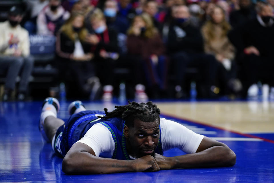 Minnesota Timberwolves' Naz Reid lays on the court after a foul during the first half of an NBA basketball game against the Philadelphia 76ers, Saturday, Nov. 27, 2021, in Philadelphia. (AP Photo/Matt Slocum)