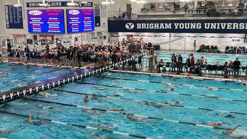 Swimmers warm-up on Friday at BYU prior to the 5A state meet preliminary races.