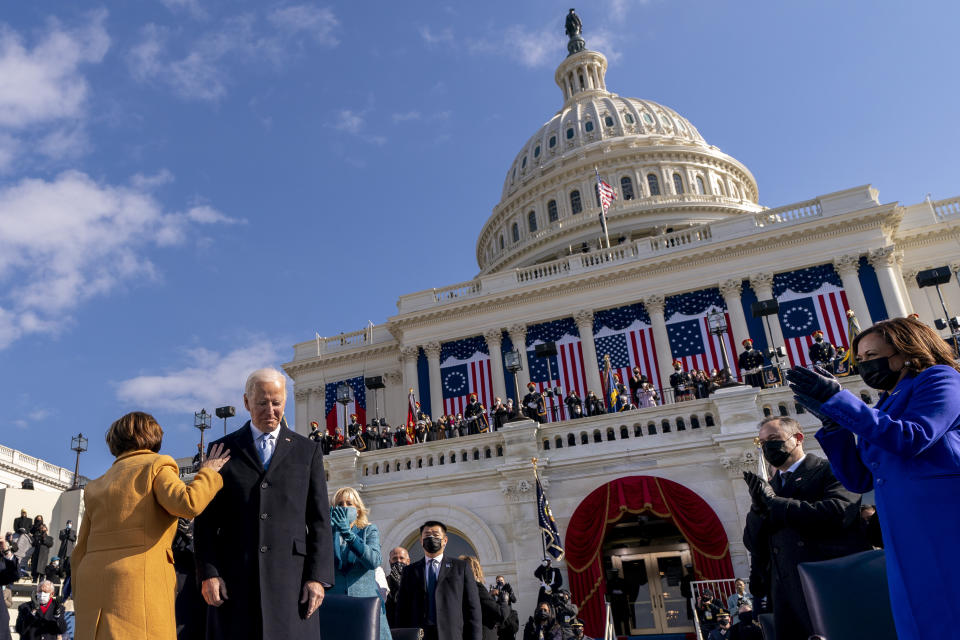 Sen. Amy Klobuchar, D-Minn., left, touches the shoulder of President Joe Biden after he is sworn in as the 46th president of the United States by Chief Justice John Roberts during the 59th Presidential Inauguration at the U.S. Capitol in Washington, Wednesday, Jan. 20, 2021, Also pictured is first lady Jill Biden, Vice President Kamala Harris, right, and her husband Doug Emhoff, second from right. (AP Photo/Andrew Harnik, Pool)