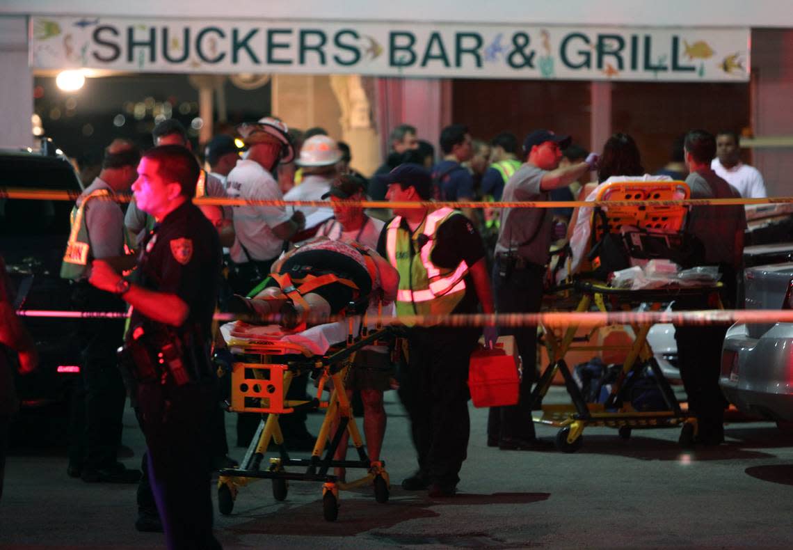 Rescue divers search for a missing person after the dock collapse at Shuckers onthe 79th Street Causeway while others are transported. Thursday June 13, 2013.