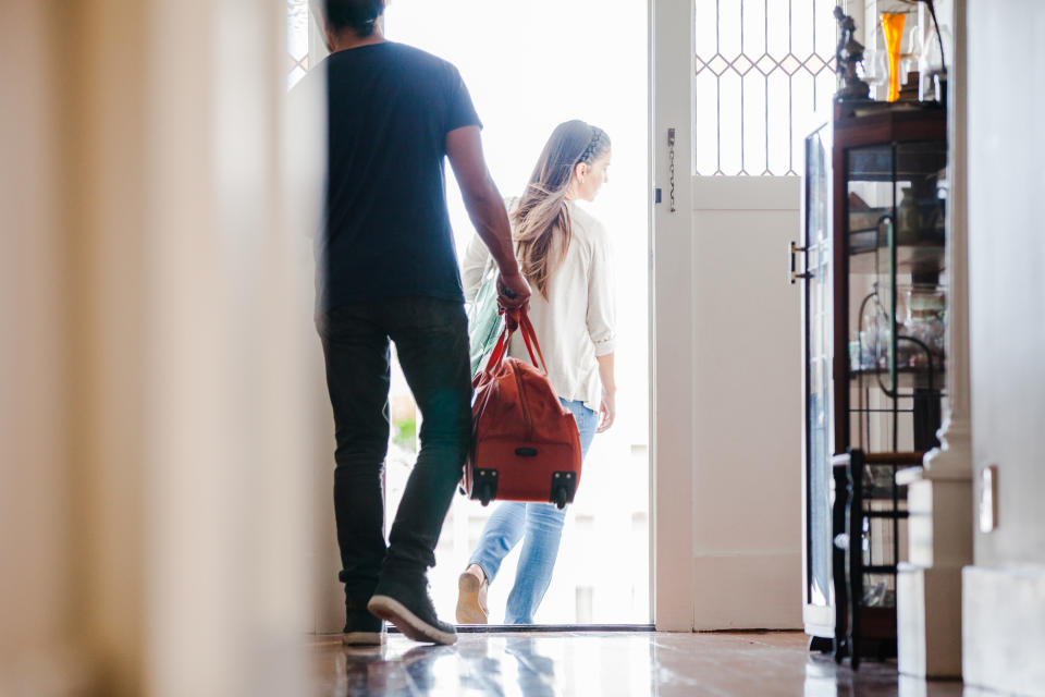 Family going for travel with bags in hand leaving home in Auckland, New Zealand.