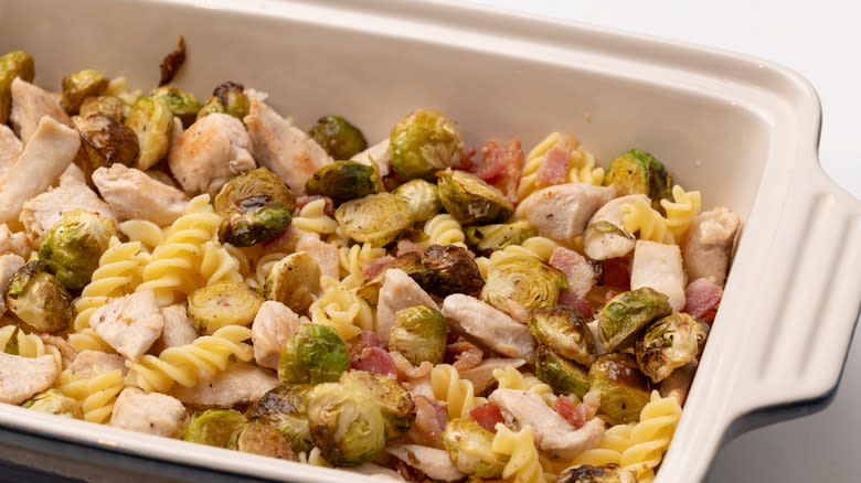 Brussel sprouts, bacon, and pasta in baking dish
