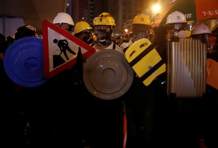 Anti-extradition demonstrators hold makeshift shields, after a march to call for democratic reforms in Hong Kong