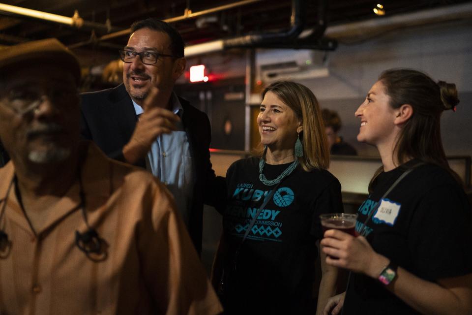 Adrian Fontes, candidate for Secretary of State speaks with Lauren Kuby, candidates for Arizona Corporation Commission,  during a watch party for the Arizona primary at Valley Bar on  Aug. 2, 2022, in Phoenix.