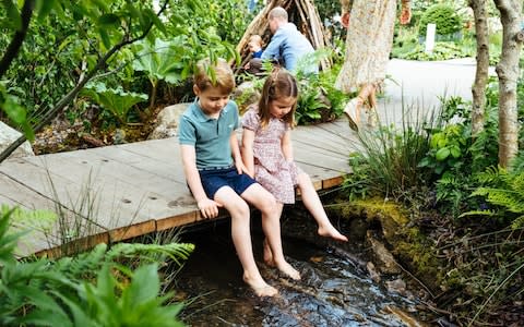 Prince George and Princess Charlotte dip their toes in the stream on a special visit on Sunday - Credit: Matt Porteous