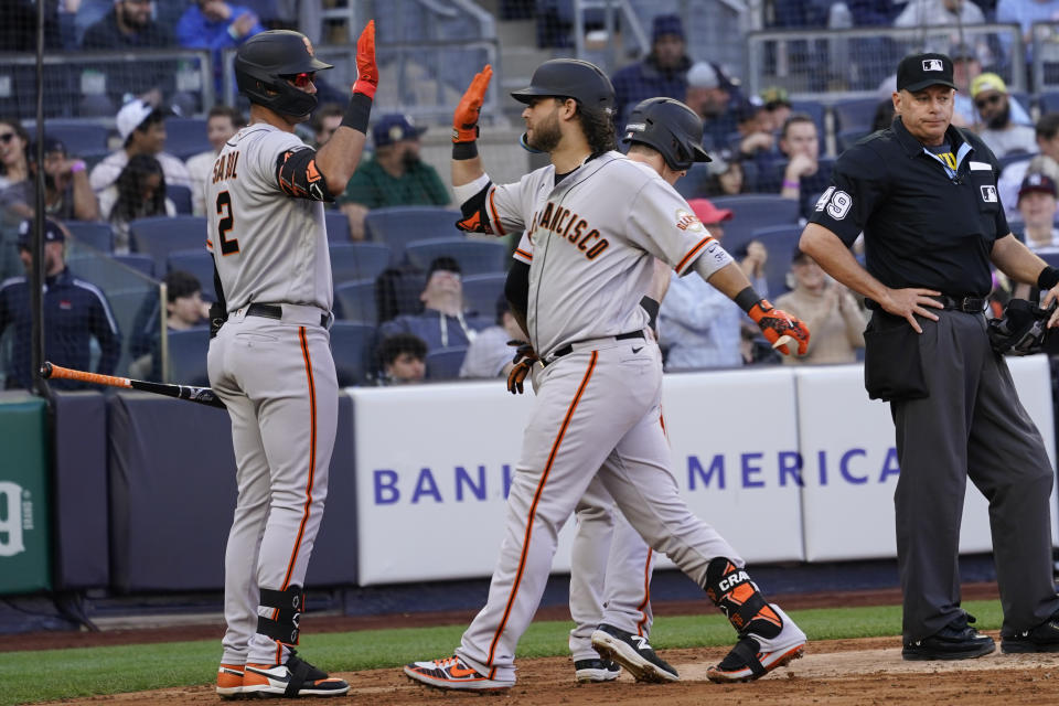 San Francisco Giants' Brandon Crawford, center front, celebrates with Blake Sabol (2) after hitting a two-run home run in the fourth inning of a baseball game against the New York Yankees, Saturday, April 1, 2023, in New York. (AP Photo/Mary Altaffer)