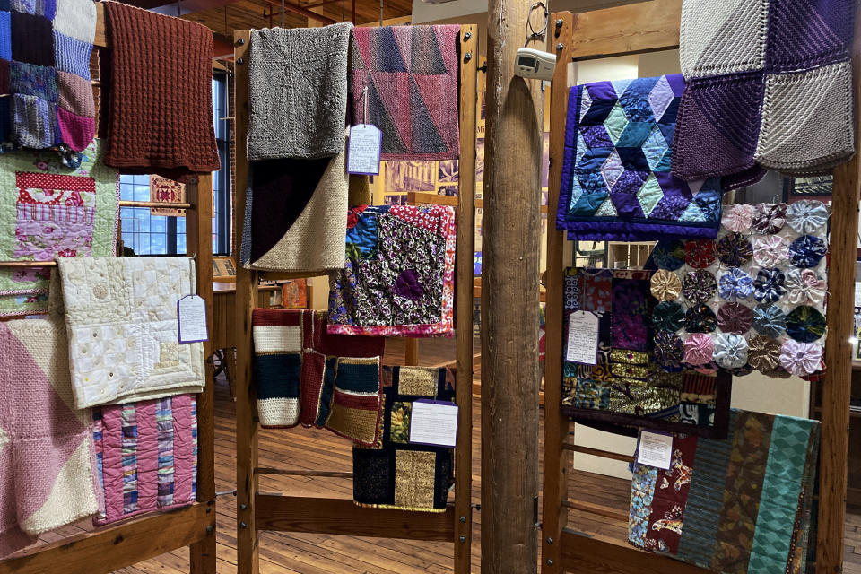 Handmade blankets for refugees are displayed during a Welcome Blanket exhibit at the Winooski Heritage Mill Museum, Feb. 17, 2023, in Winooski, Vt. The blankets were made by Vermont and out-of-state crafters to welcome refugees to the community as part of the national Welcome Blanket project. The blankets with personal notes from the creators about their own family's history about immigration were given away to refugees at an event on Tuesday, March 21, in Burlington, Vt. (AP Photo/Lisa Rathke)