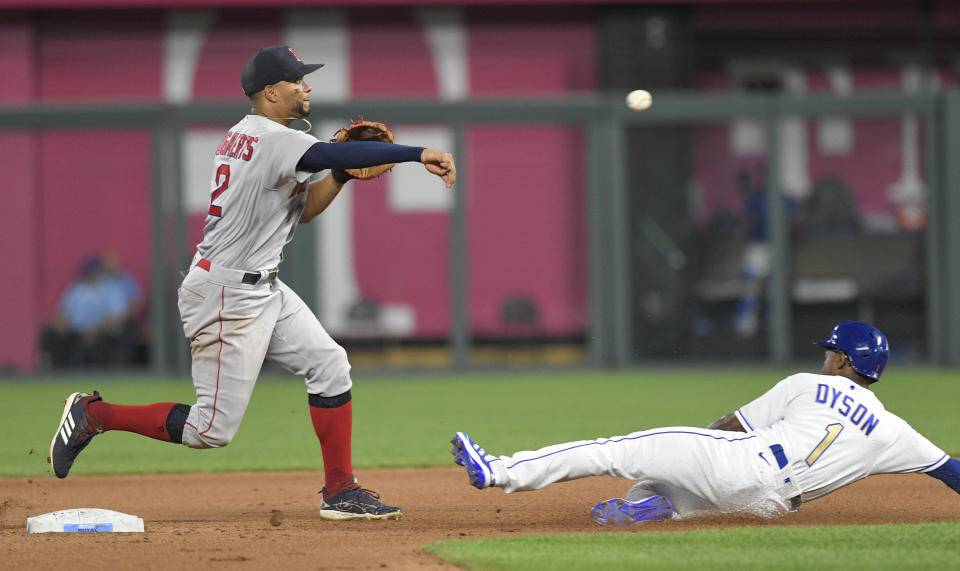 Boston Red Sox shortstop Xander Bogaerts, left, throws over a sliding Kansas City Royals' Jarrod Dyson for a double play against Royals batter Adalberto Mondesi during the seventh inning of a baseball game in Kansas City, Mo., Friday, June 18, 2021. (AP Photo/Reed Hoffmann)