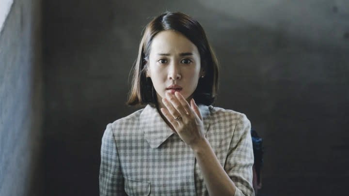 Mrs. Park covering her mouth with her hand in Parasite.