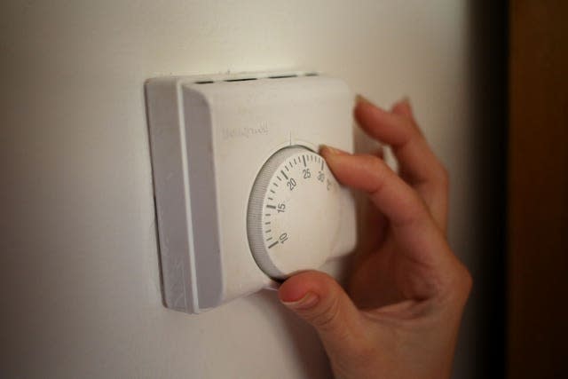 File photo dated 19/09/13 of a person using a central heating thermostat