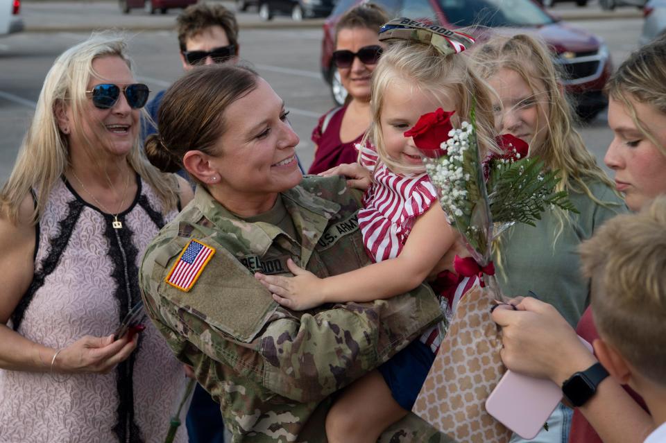 Staff Sgt. Whitney Belwood of St. Wendel, Ind., scoops up her daughter, 3-year-old Alora, during the send-off for the Indiana National Guard 1st Battalion, 163rd Field Artillery at the Christian Fellowship Church in Evansville Tuesday evening, Aug. 9, 2022. The group is heading to Iraq as part of a coalition security forces mission.