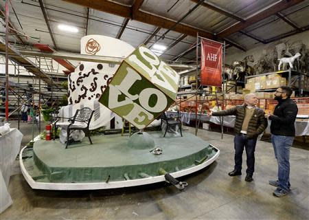 Danny Leclair (R) and Aubrey Loots look at the AIDS Healthcare Foundation (AHF) Tournament of Roses Parade parade float at Fiesta Parade Floats in Irwindale, California on December 30, 2013. REUTERS/Kevork Djansezian