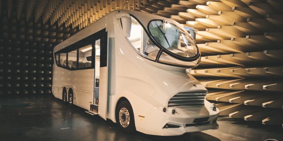 One of Marchi Mobile's large RVs on the road in a unique showroom.
