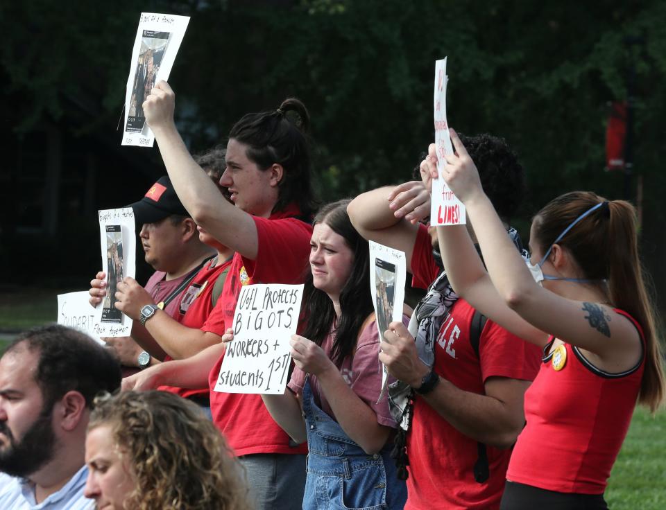 A group of a dozen or more protested silently during the inauguration of UofL President Kim Schatzel in front of Grawemeyer Hall on Friday, September 29, 2023.  Schatzel becomes the university’s 19th president.  