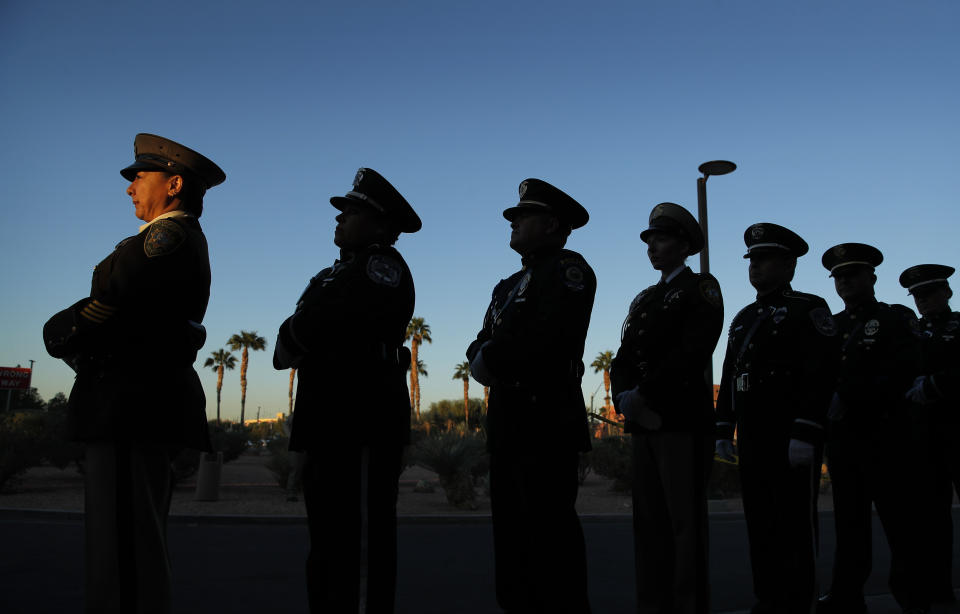 Members of a law enforcement honor guard stand in line during a ceremony Tuesday, Oct. 1, 2019, on the anniversary of the mass shooting two years earlier in, Las Vegas. (AP Photo/John Locher)