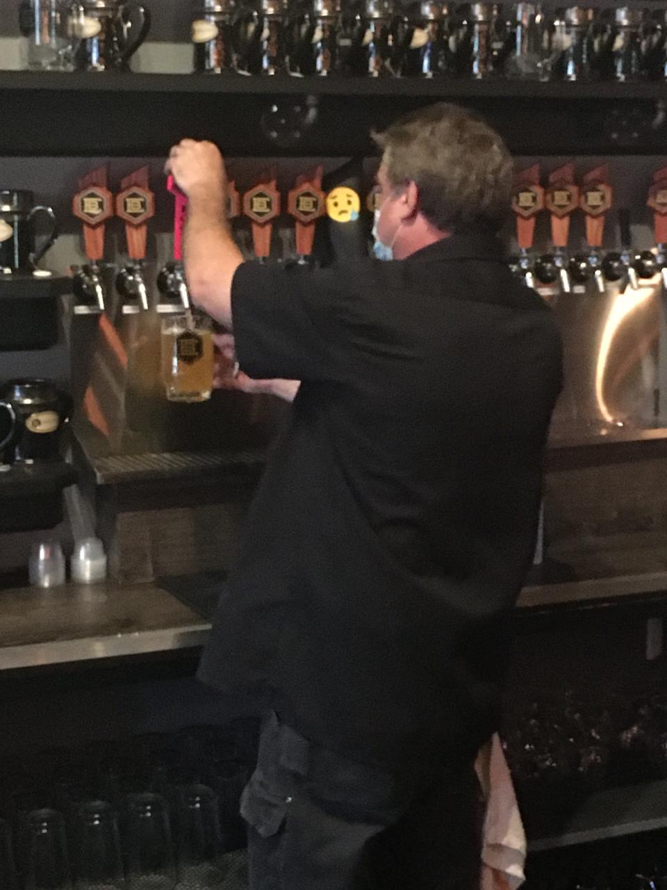 Epicure Brewing Owner Ken Thiffeault pours a beer Thursday. Bars, breweries and other drinking establishments will be able to serve drinks again to patrons outside without them buying food starting Saturday.
