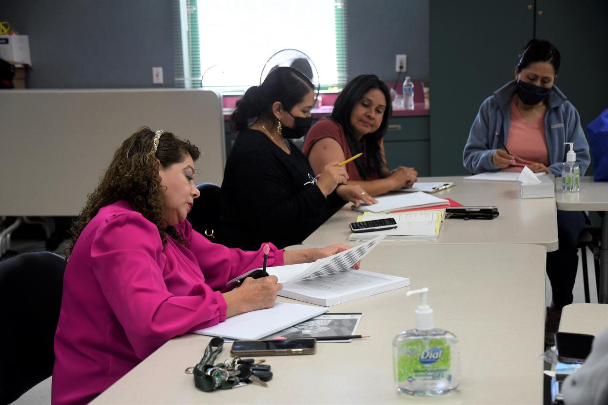 Teacher Oralia Villanueva assists students in a class for Spanish speakers at the Alisal Family Resource Center in Salinas, Calif.