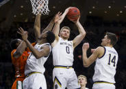 Notre Dame's Rex Pflueger (0) grabs a rebound during the first half of an NCAA college basketball game against Miami on Sunday, Feb. 23, 2020, in South Bend, Ind. (AP Photo/Robert Franklin)