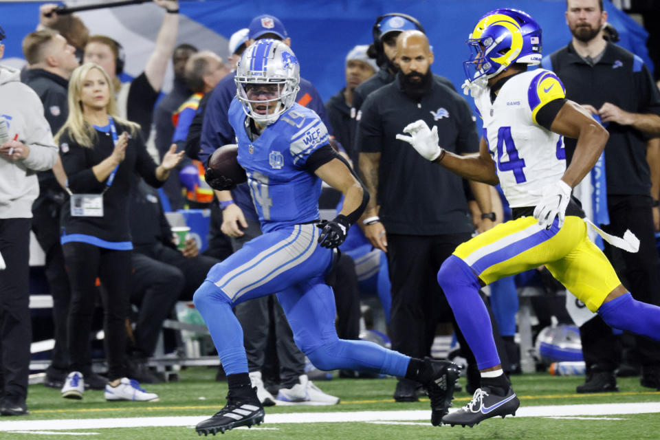 Detroit Lions wide receiver Amon-Ra St. Brown (14) is chased by Los Angeles Rams cornerback Ahkello Witherspoon (44) during the second half of an NFL wild-card playoff football game, Sunday, Jan. 14, 2024, in Detroit. (AP Photo/Duane Burleson)