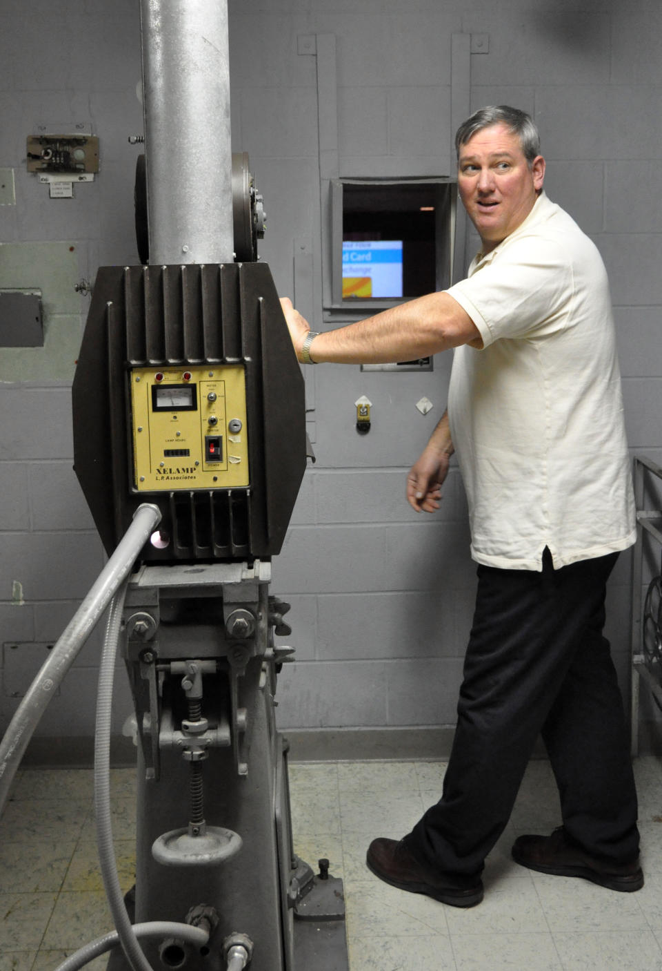 Ron Reynolds, projectionist for the Ellsworth Air Force Base theater, prepares to start a reel showing "Hotel Transylvania" on the South Dakota film house's last day of operation, Saturday, Jan. 19, 2013. The Army and Air Force Exchange Service theater serving airmen and their families is one of 60 across the globe that's closing because it's too expensive to switch from 35 millimeter film prints to an all-digital projection format. (AP Photo/Dirk Lammers)