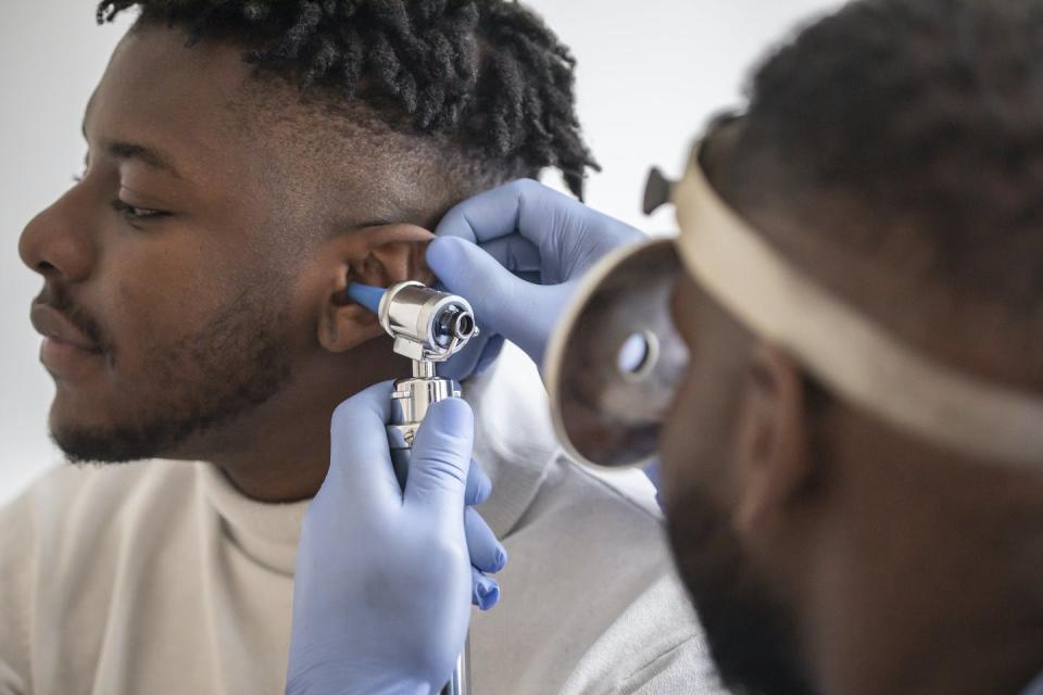 Prohibitive costs and appointment hurdles can discourage patients from obtaining hearing aids. <a href="https://www.gettyimages.com/detail/photo/close-up-of-a-doctor-checking-the-ear-of-his-male-royalty-free-image/1310935018" rel="nofollow noopener" target="_blank" data-ylk="slk:Vladimir Vladimirov/E+ via Getty Images;elm:context_link;itc:0;sec:content-canvas" class="link ">Vladimir Vladimirov/E+ via Getty Images</a>