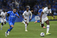 Saudi Arabia's Al Hilal's Michael Delgado, left, fights for the ball with a UAE's Al Ain player during the second leg of their AFC Champions League 2023/24 semi-final match at Kingdom Arena Stadium in Riyadh, Saudi Arabia,Tuesday, April 23, 2024. (AP Photo)