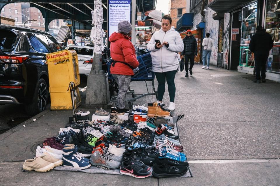 Migrant vendors sell their stolen goods on blankets and beach towels, which can be picked up and stashed if the police show up. Stephen Yang