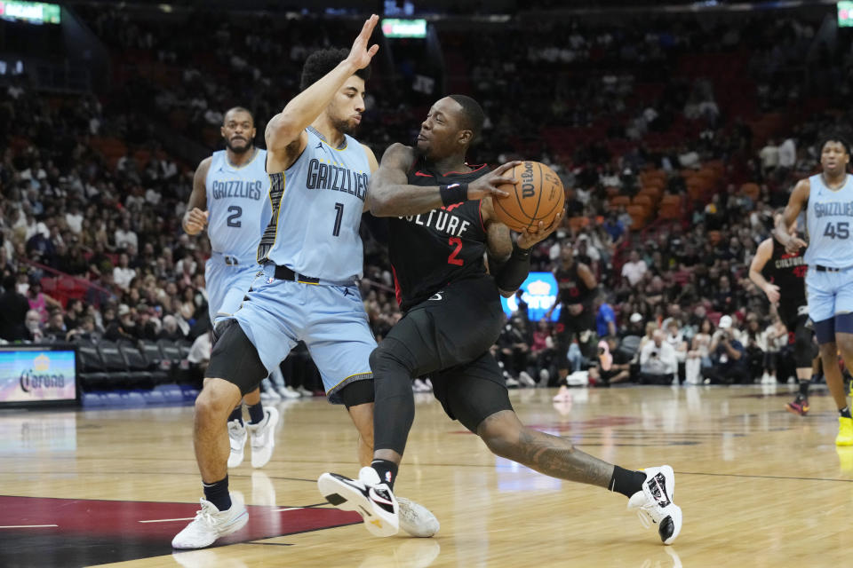 Miami Heat guard Terry Rozier (2) dribbles the ball as Memphis Grizzlies guard Scotty Pippen Jr. defends during the first half of an NBA basketball game, Wednesday, Jan. 24, 2024, in Miami. (AP Photo/Marta Lavandier)