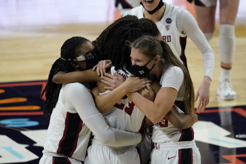 Stanford players celebrate at the end of a women's Final Four NCAA college basketball tournament semifinal game against South Carolina Friday, April 2, 2021, at the Alamodome in San Antonio. Stanford won 66-65. (AP Photo/Eric Gay)