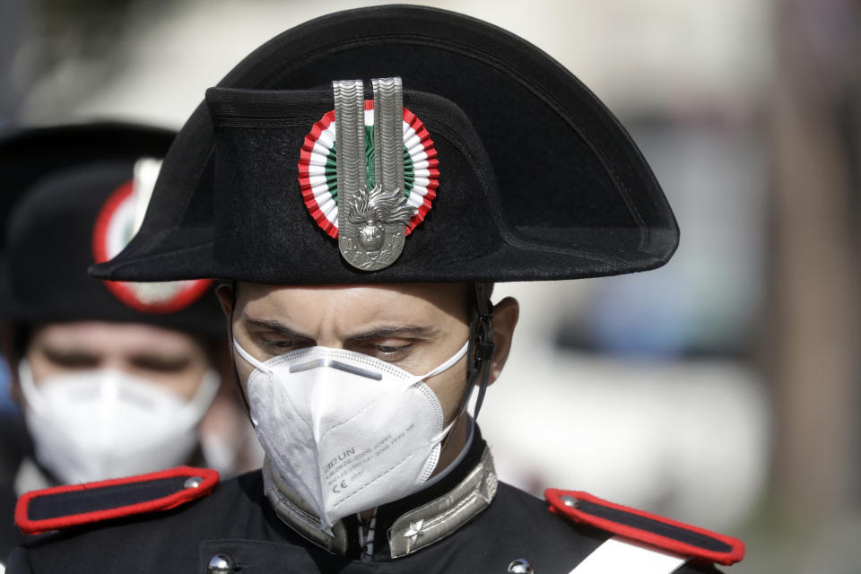 A Carabinieri officer attends the funeral of the Italian ambassador to the Democratic Republic of Congo Luca Attanasio and Italian Carabinieri police officer Vittorio Iacovacci, in Rome, Thursday, Feb. 25, 2021. Italy paid tribute Thursday to its ambassador to Congo and his bodyguard who were killed in an attack on a U.N. convoy, honoring them with a state funeral and prayers for peace in Congo and all nations "torn by war and violence." (AP Photo/Andrew Medichini)