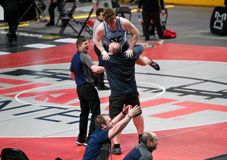 Central Valley's Brenan Morgan celebrates with the Warriors' coaching staff after picking up a thrilling 4-3 decision win over Girard's Abraham Keep in the Class 2A 215-pound semifinal Friday in Hershey. Morgan scored a takedown with 30 seconds left to pick up the 4-3 win.