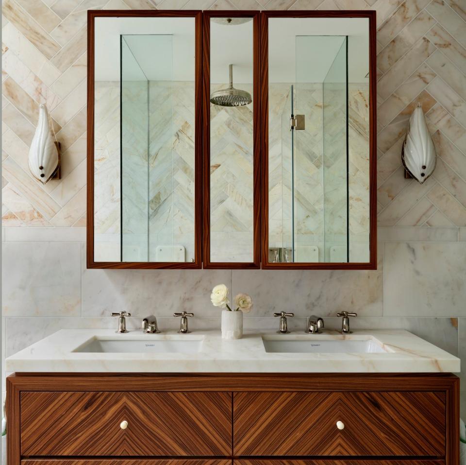 A mix of herringbone and large-format rectangular tiles were used for the bathroom