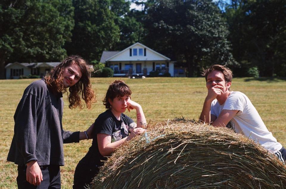 Jake Lenderman (left) and Karly Hartzman (middle) pose outside of the homes at the 767 New Haw Creek property.