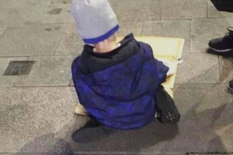 A heart-breaking image of a young homeless boy eating his dinner out of a cardboard box on the pavement of a city street in Ireland has caused widespread outcry on social media. (Facebook) 