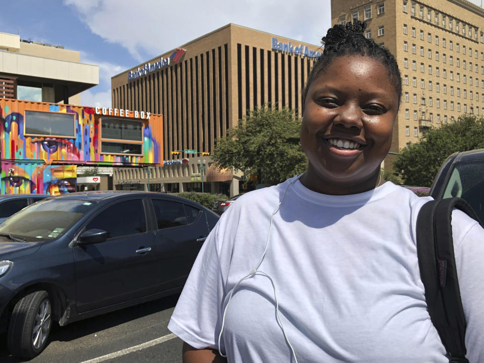 In this Aug. 4, 2019, photo, Infinity Tucker poses in El Paso, Texas. Tucker, an El Paso native who identifies as Afro-Latina, spoke about Sunday’s shooting in El Paso. “He’s a grown man,” the 23-year-old said of the suspected killer. “He’s able to make his own choices.” (AP Photo/Astrid Galván)