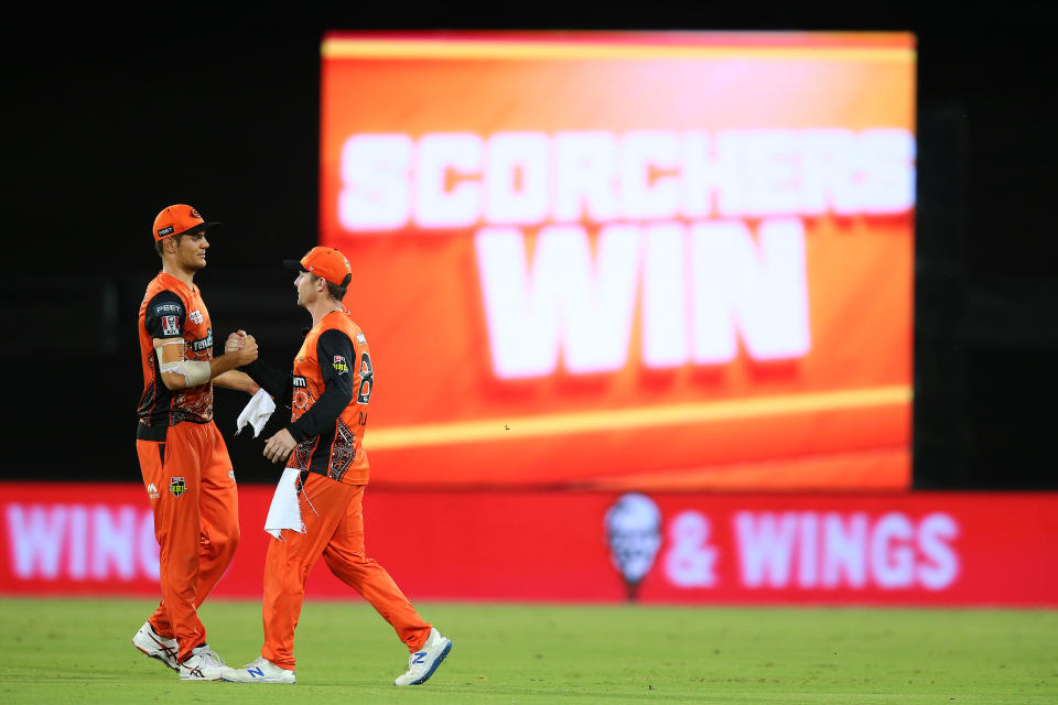 Aaron Hardie of the Scorchers and Colin Munro of the Scorchers celebrate victory during the Big Bash League 'Challenger Final' match between the Perth Scorchers and Brisbane Heat.