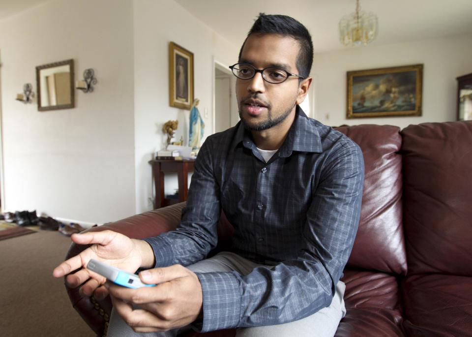 Yves Gomes, a student at the University of Maryland, who's parents were deported, poses for a photo inside his great uncle's house where he lives in Silver Spring, Md., Friday Jan. 17, 2014. Gomes says he considers himself one of the lucky ones _ lucky, at least, among the so-called “DREAMers.” Even though his parents were deported and his legal status was once in limbo, today the 21-year-old Indian native attends the University of Maryland paying in-state tuition. ( AP Photo/Jose Luis Magana)