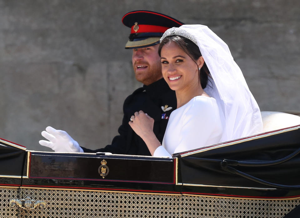 Meghan Markle and Prince Harry ride in an Ascot Landau carriage at Windsor Castle after their wedding (Picture: PA)