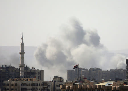 Smoke rises from Yarmouk Palestinian camp in Damascus, Syria April 20, 2018. REUTERS/Ali Hashisho