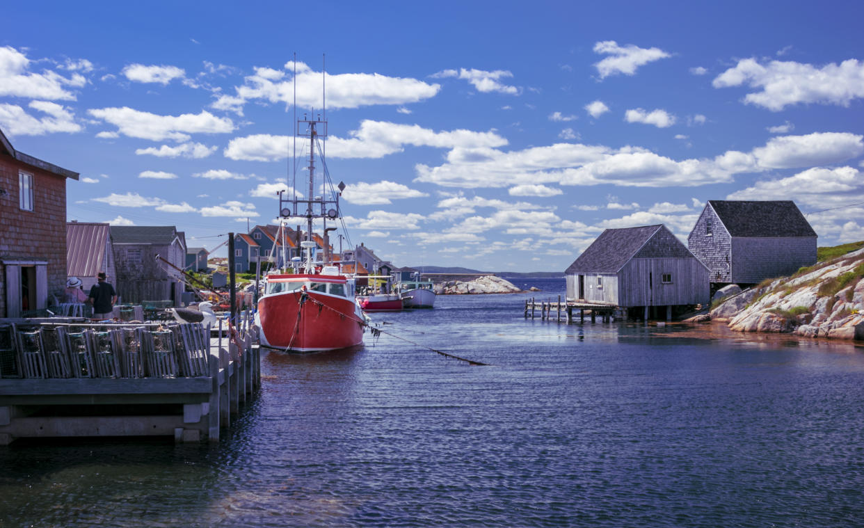 Boats docked at the wharf on a beautiful summer's day in Nova Scotia's iconic fishing community of Peggy's Cove.