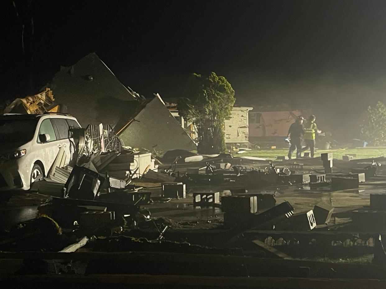 Portage Department of Public Safety firefighters work to render safe ruptured natural gas lines in the aftermath of a tornado that touched down Tuesday, May 7.