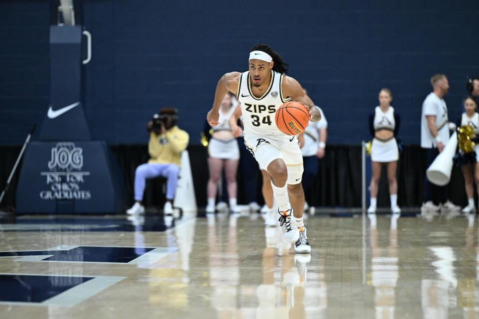 University of Akron men's basketball player Nate Johnson dribbles up the court against Miami-Hamilton on Dec. 17, 2023.