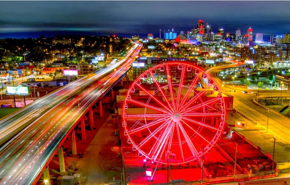 The 150-foot tall Ferris wheel glows in the night at Pennway Point at the nearly 6-acre entertainment district being developed by 3D Development of Kansas City.