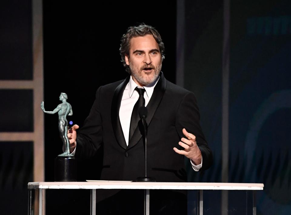 Joaquin Phoenix accepts his best actor award for “Joker” and celebrates his fellow nominees during the 26th annual Screen Actors Guild Awards.