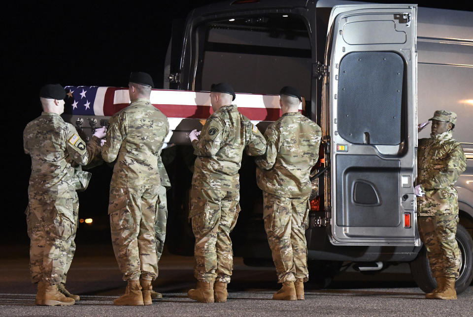 An Army carry team moves a transfer case containing the remains of Spc. Branden Tyme Kimball, early Friday, Feb. 14, 2020, at Dover Air Force Base, Del. According to the Department of Defense, Kimball, 21, of Central Point, Ore., died at Bagram Airfield, Afghanistan, from a non-combat related incident. (AP Photo/Steve Ruark)