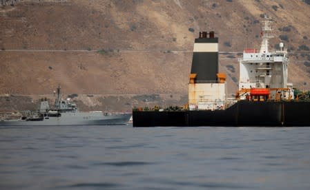 A British Royal Navy patrol vessel guards the Iranian oil tanker Grace 1 as it sits anchored after it was seized earlier this month by British Royal Marines in the Strait of Gibraltar