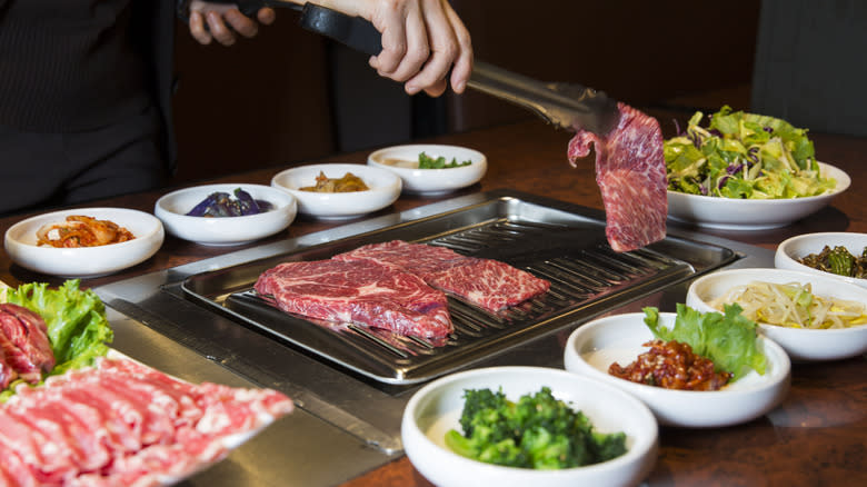 chef cooking meat a Korean BBQ restaurant