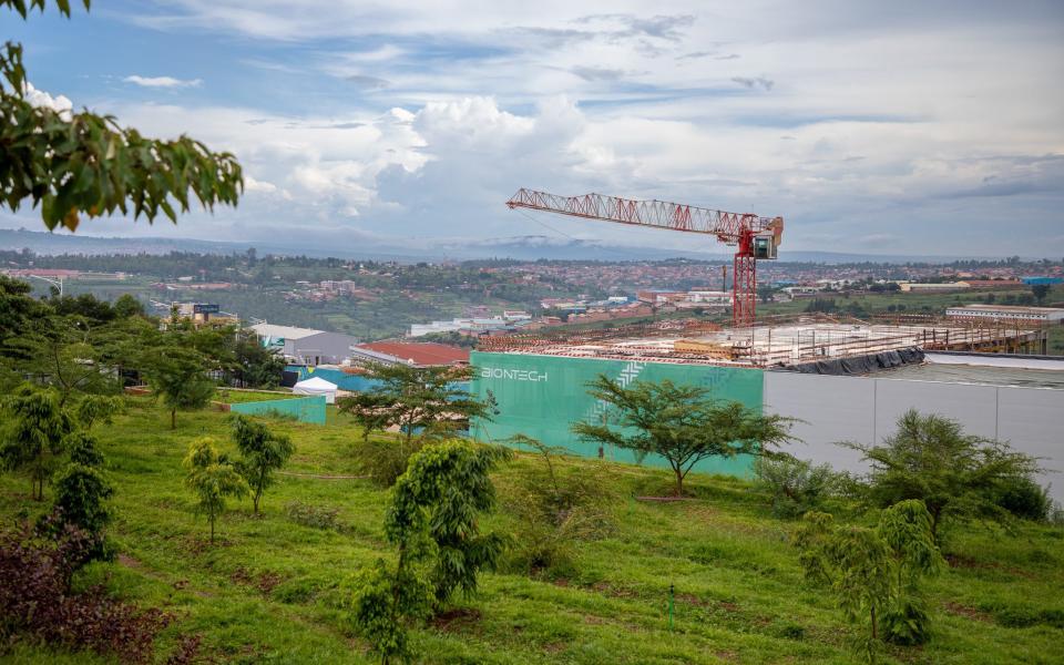 The new production facility is surrounded by the lush green hills of Kigali