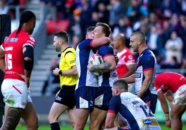 England’s Tom Johnstone (centre right) celebrates after scoring a try against Tonga